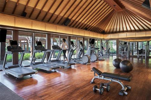 a gym with a bunch of exercise equipment in it at Hyatt Regency Bali in Sanur
