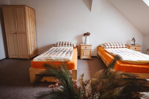 a room with two beds and a cabinet at Zámek Spálené Poříčí in Spálené Poříčí