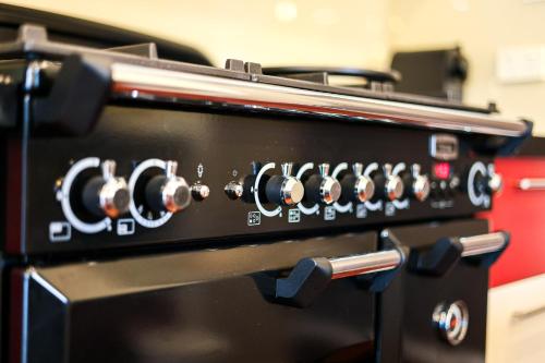 a close up of a stove top oven at StayAU Pakenham Townhouse with Lakeview in Pakenham