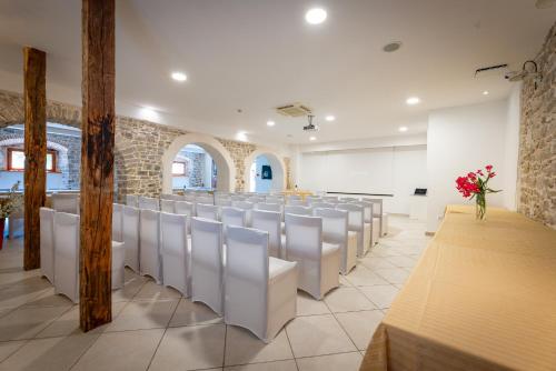a room with a row of chairs in a church at Boutique Hotel Kaštel in Motovun
