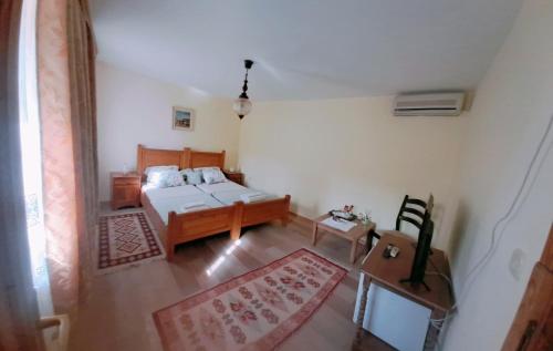 a living room with a bed and a table at Guest House Pocitelj in Počitelj