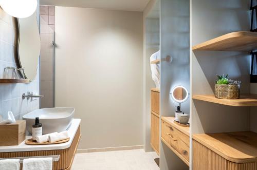 a bathroom with a white sink and a shower at WALDWEIT Rheingau Hotel und Retreat in Kiedrich