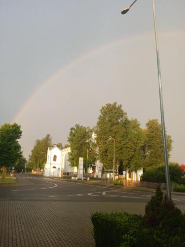 a rainbow in the sky over a street at Svečių namai Alėjos Ąžuolas in Druskininkai