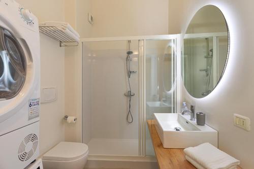 a bathroom with a shower and a sink and a toilet at Hotel Ancora in Verbania