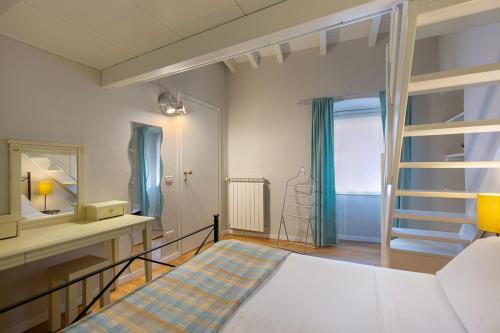 a bedroom with a bed and a mirror at Hotel Ancora in Verbania
