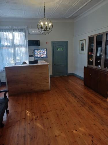 an empty office with a desk in a room at Triple9 Hatfield Guesthouse in Pretoria