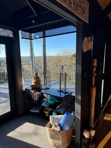 a living room with a large window with a view at Green Buddha in Milton