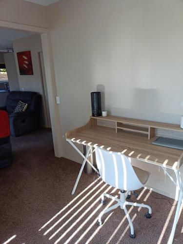 a desk and a chair in a room at Executive Hideaway in Christchurch