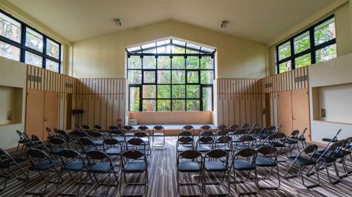 an empty room with chairs and a large window at Motosu Phoenix Hotel in Fujikawaguchiko