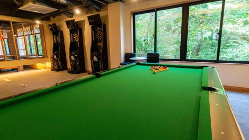 a green pool table in a room with skateboards at Motosu Phoenix Hotel in Fujikawaguchiko