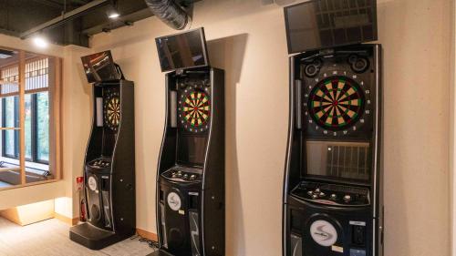 three arcade machines are lined up against a wall at Motosu Phoenix Hotel in Fujikawaguchiko