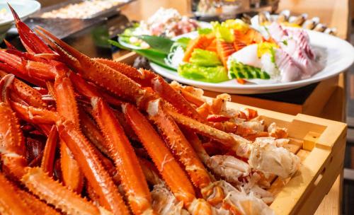 a tray of carrots and a plate of salad at Motosu Phoenix Hotel in Fujikawaguchiko