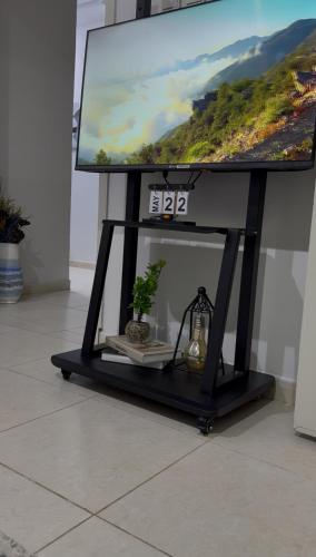 a television on a stand with a tv on it at شقة الراحة والفخامة in Khamis Mushayt
