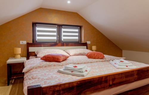 a bedroom with a large bed with towels on it at Guest house Oasis of Peace in Gačice