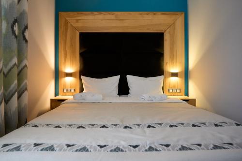 a bedroom with a large bed with two pillows at Goral Hotel & Spa in Bukovel