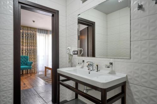 a bathroom with a sink and a mirror at Goral Hotel & Spa in Bukovel