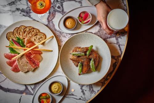 a table with three plates of food on it at Hyatt Regency Tokyo in Tokyo