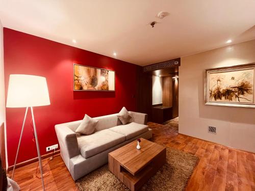 a living room with a couch and a table at Hotel Senses in Kolkata