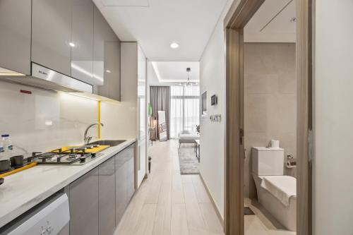 a kitchen with a sink and a counter top at Elite Escape - Getaway in Azizi Riviera 13 in Dubai
