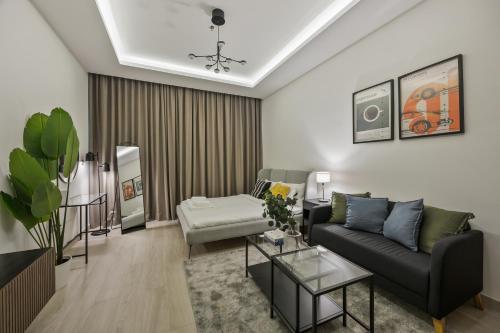 a living room with a couch and a table at Elite Escape - Getaway in Azizi Riviera 13 in Dubai