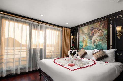 a bedroom with a large bed with a heart on it at Athena Royal Cruise - Luxury in Halong Bay in Ha Long