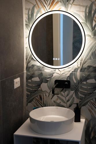 a bathroom with a sink and a mirror on the wall at NoMad Guest House in La Spezia