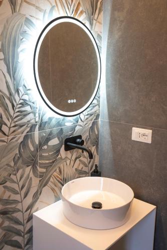 a bathroom with a sink and a mirror on the wall at NoMad Guest House in La Spezia