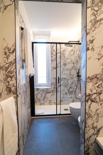 a bathroom with a shower and a toilet and a sink at NoMad Guest House in La Spezia