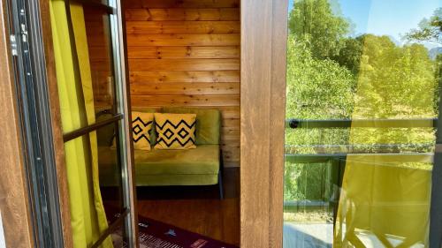 a sliding glass door with a bench in a room at ANDRIANA Mountain Home - ASPRIAS 