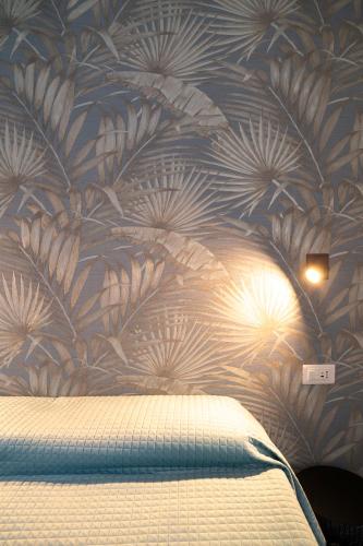 a bedroom with a blue and white floral wallpaper at NoMad Guest House in La Spezia