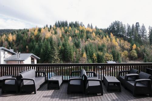 a balcony with chairs and a view of a mountain at Goral Hotel & Spa in Bukovel