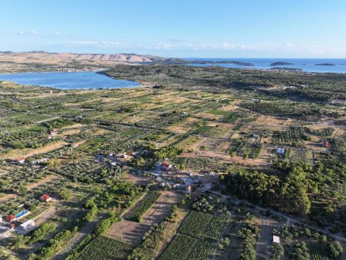 an aerial view of a farm with water and trees at Vranac Country house Šibenik in Donje Polje