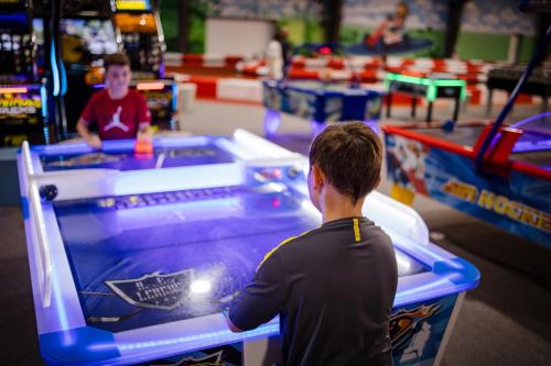 a young boy playing a video game in a arcade at Thermenhotel Kurz in Lutzmannsburg