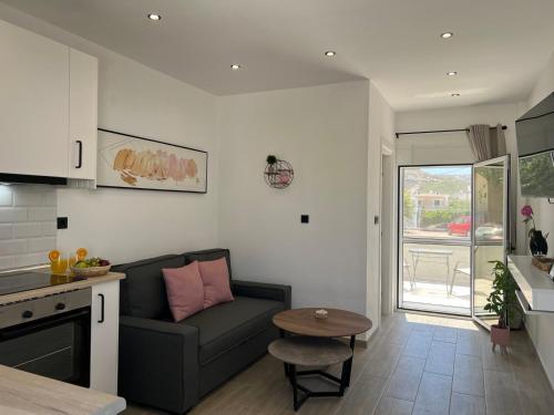 a living room with a couch and a table at PAME apartments in Kámpos