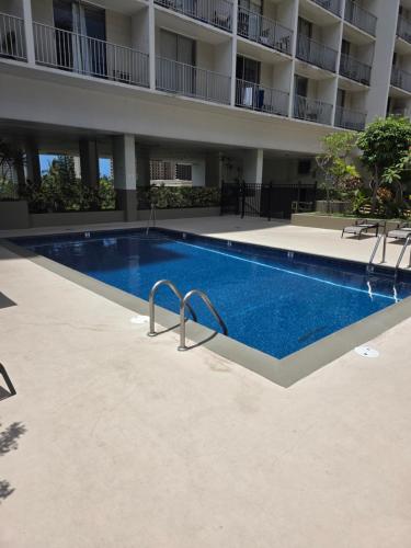 a swimming pool in front of a building at Waikiki Vacation Apartment in Honolulu