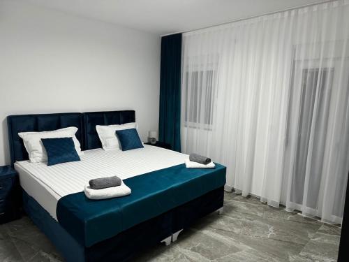 a bedroom with a large bed with blue and white at AD Homes in Ravanj