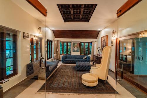 a living room with a glass wall at Madilina Heritage Villa in Parūr