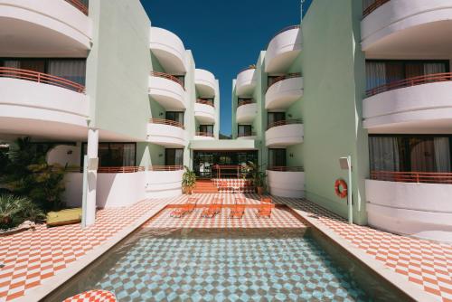 an external view of a building with a swimming pool at Cubanito Ibiza in San Antonio