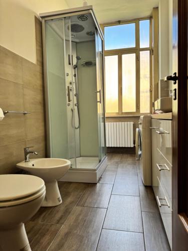 a bathroom with a shower and a toilet and a sink at casa Martina - LuxRental Apartments in Pescara
