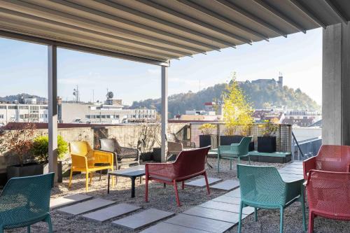 a group of chairs and tables on a patio at ibis Styles Ljubljana Centre in Ljubljana