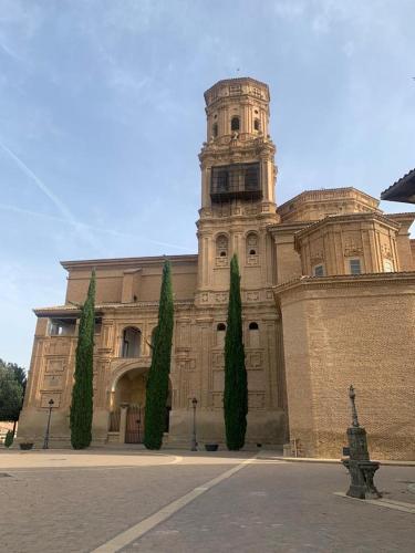 a large building with a tower on top of it at Apartamento rural Las Cañas Esencia de Bardenas in Villafranca