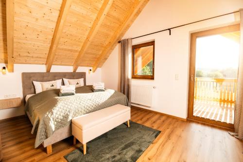 a bedroom with a bed and a large window at Chalet Heimatzeit in Reichenbach