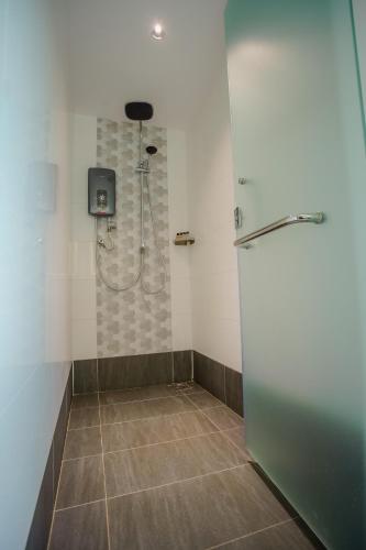 a bathroom with a shower with a refrigerator at NB HOTEL in Johor Bahru