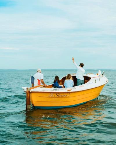 a group of people on a yellow boat in the water at Cottage Prestige 641 in La Teste-de-Buch