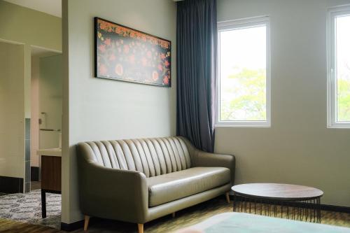 a living room with a couch and two windows at NB HOTEL in Johor Bahru