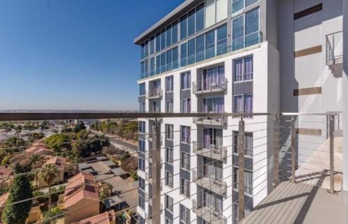 an apartment building with a view of a city at Sandton Pool View with Balcony in Johannesburg