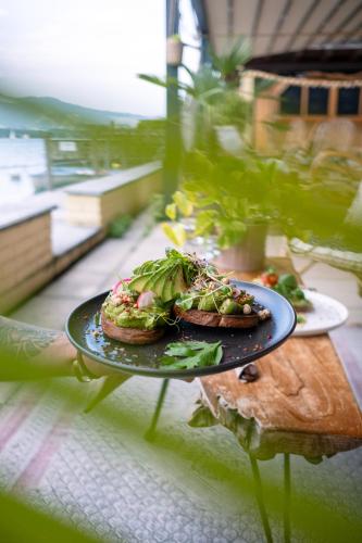 a plate of food with a sandwich on a table at Room's at HAUS am SEE direkt am Thunersee gelegen mit SELF CHECK IN & digitaler Rezeption in Oberhofen am Thunersee