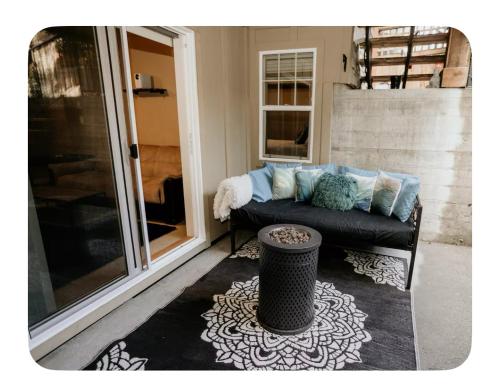 a couch sitting on a porch next to a window at Lower suite in family friendly townhome in Victoria
