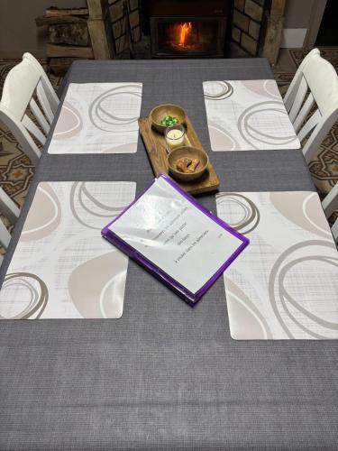 a table with a purple book on top of it at Lydie in Pressigny