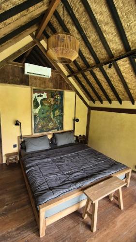 a bedroom with a large bed in a room at Lotus Forest Houses in Ngingas
